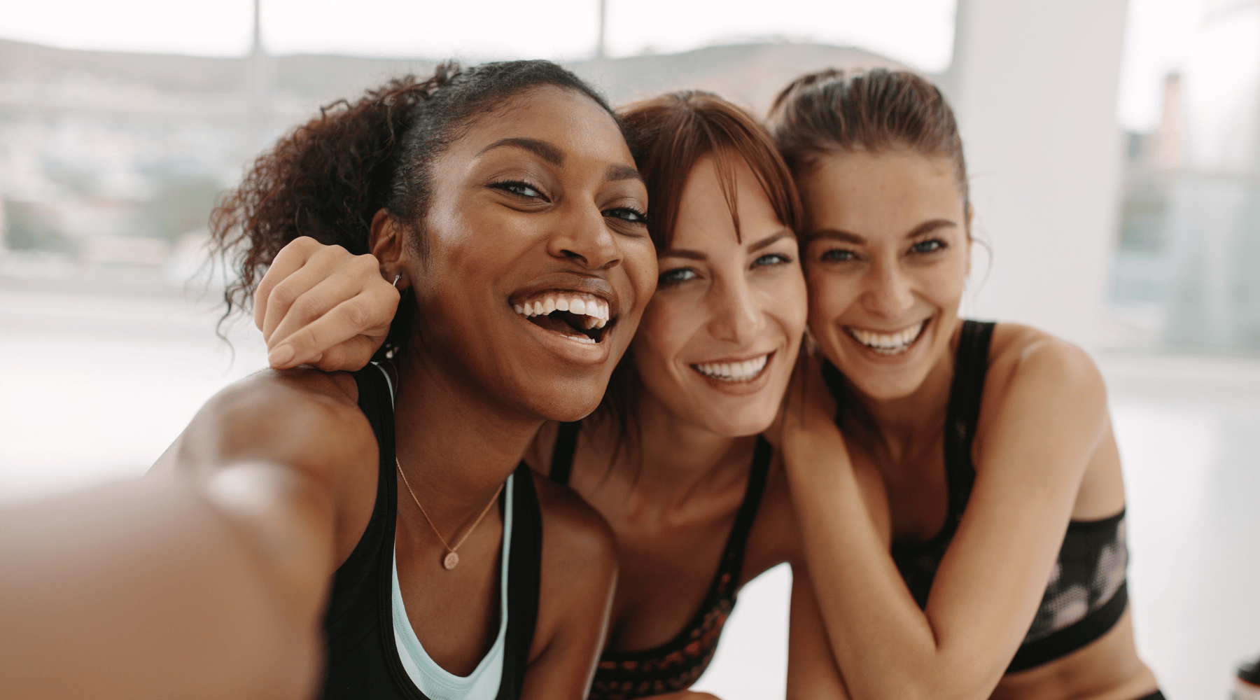 Three smiling women image with link to information about Biotin for strong hair and nail growth